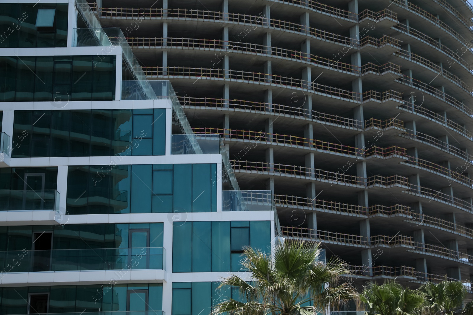 Photo of Modern and unfinished buildings outdoors. Construction site