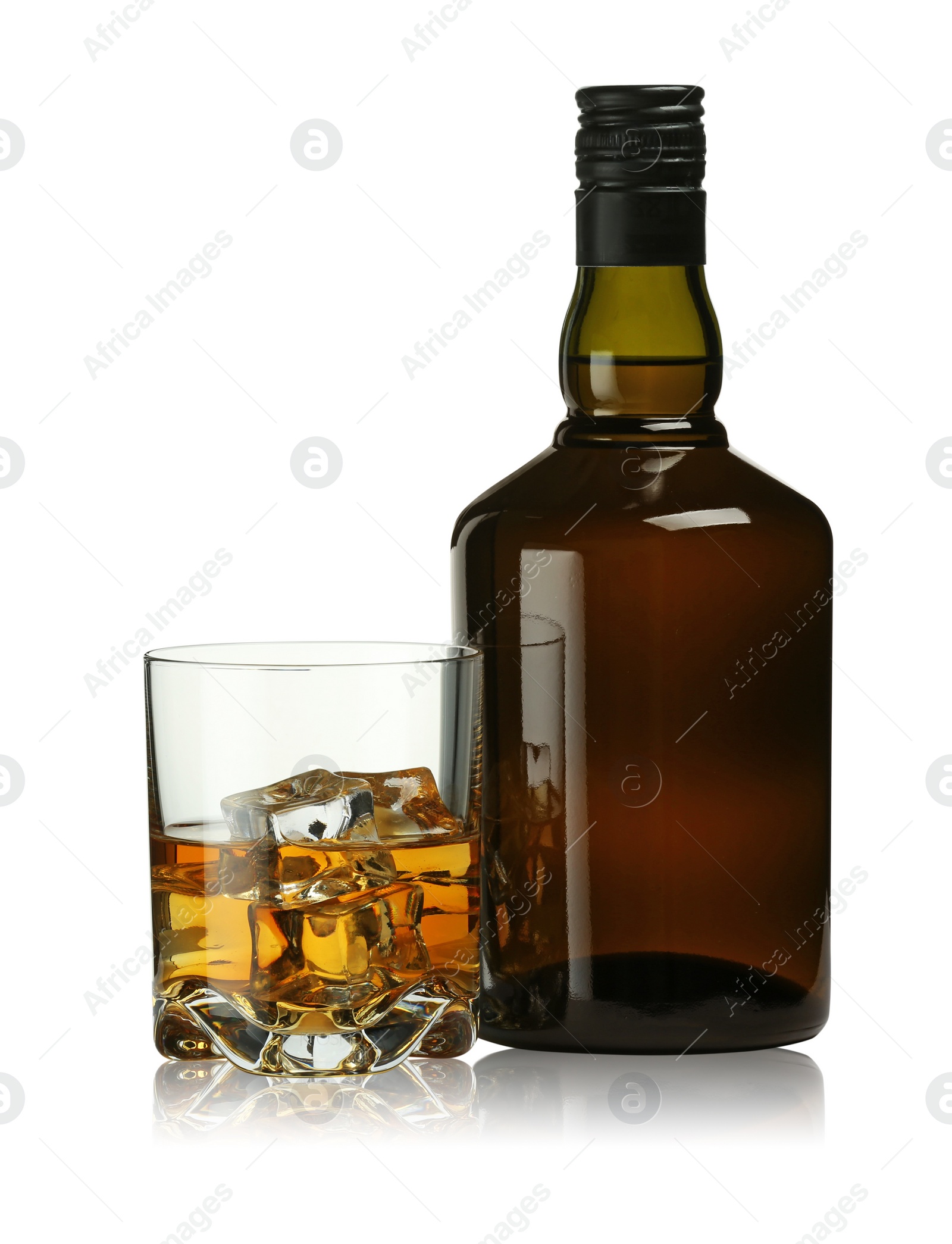 Photo of Whiskey in glass and bottle isolated on white