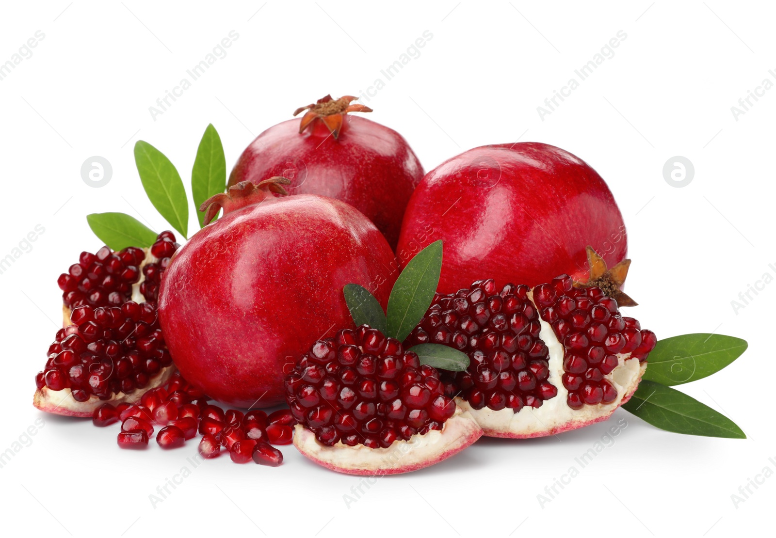 Photo of Tasty ripe pomegranates and leaves on white background