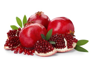 Photo of Tasty ripe pomegranates and leaves on white background