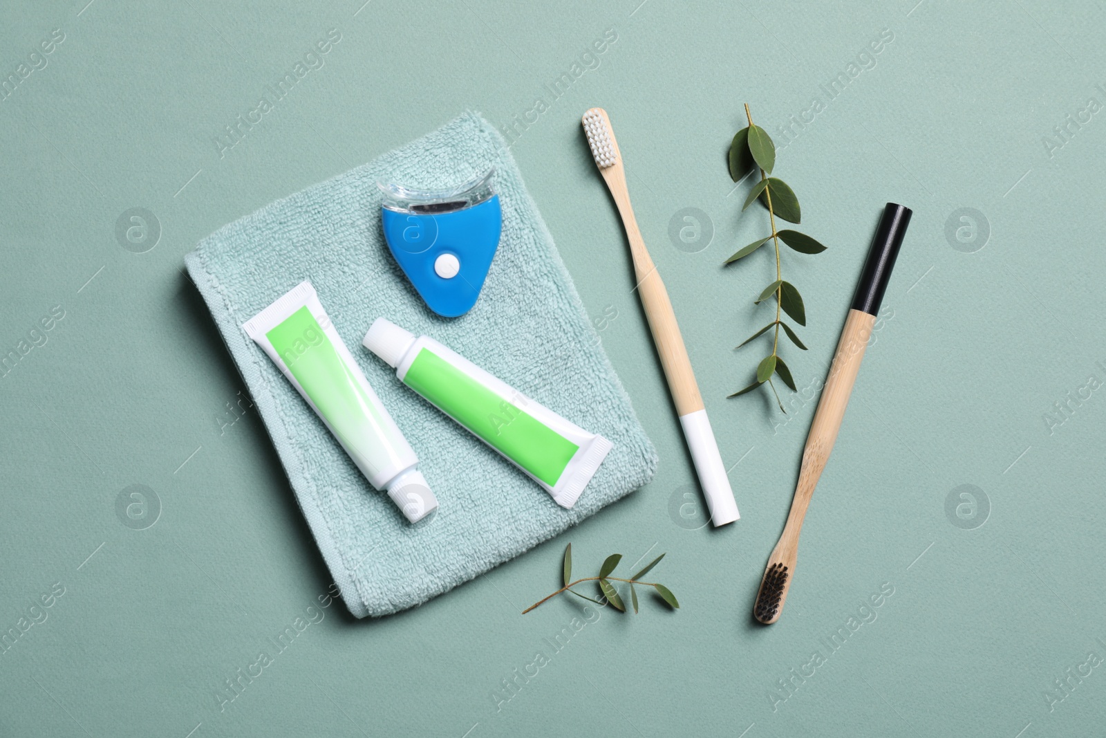 Photo of Flat lay composition with teeth care items on light grey blue background