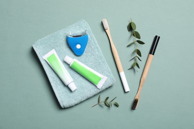 Flat lay composition with teeth care items on light grey blue background