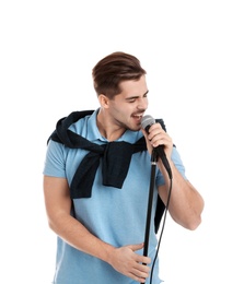 Photo of Young handsome man in casual clothes singing with microphone on white background