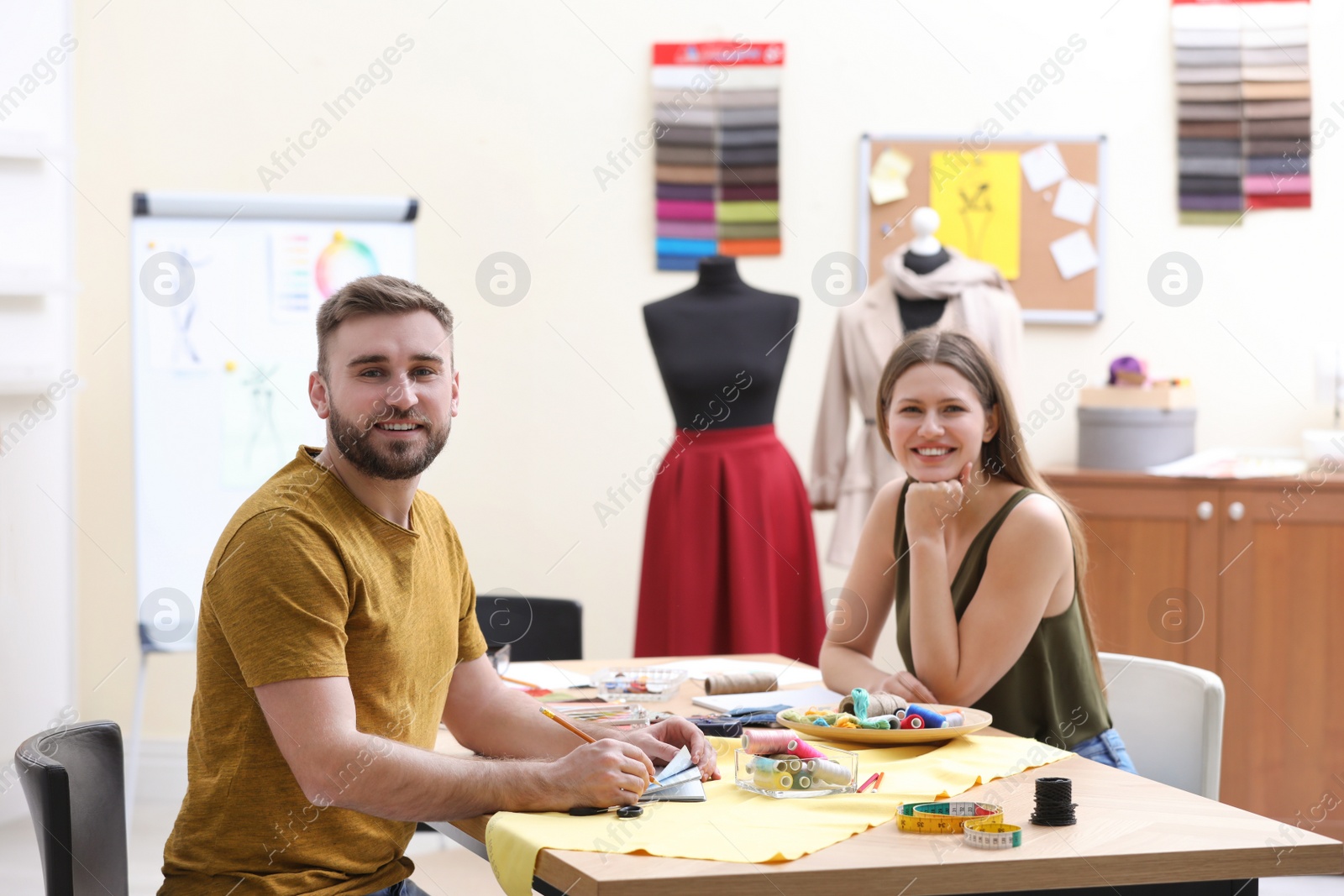 Photo of Fashion designers creating new clothes in studio