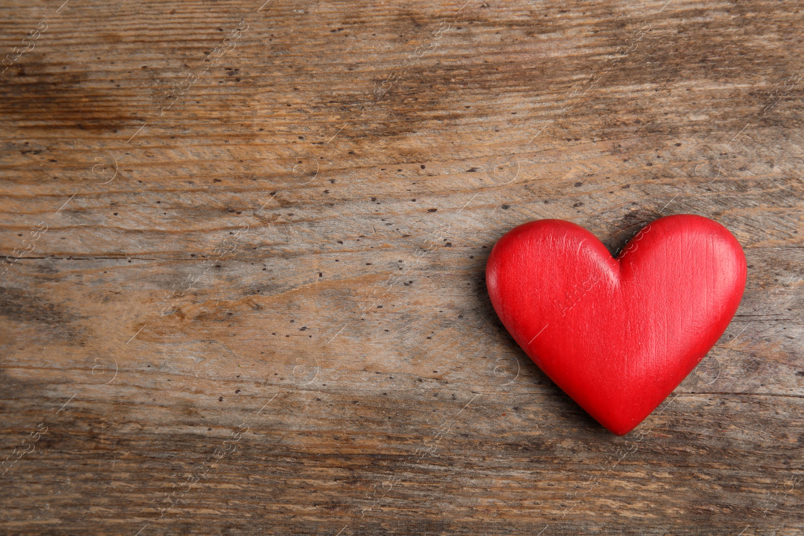 Photo of Red heart on wooden table, top view with space for text. Concept of help