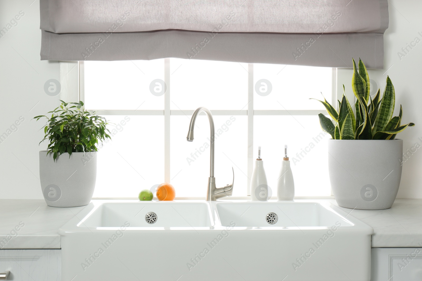 Photo of Ceramic sink and modern tap in stylish kitchen interior