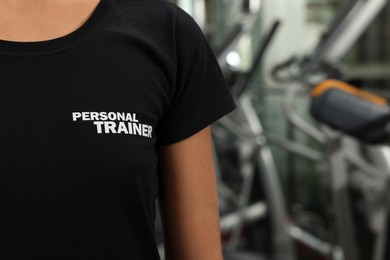 Photo of Personal trainer in modern gym, closeup view