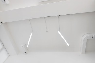 Ceiling with modern lights in room, low angle view