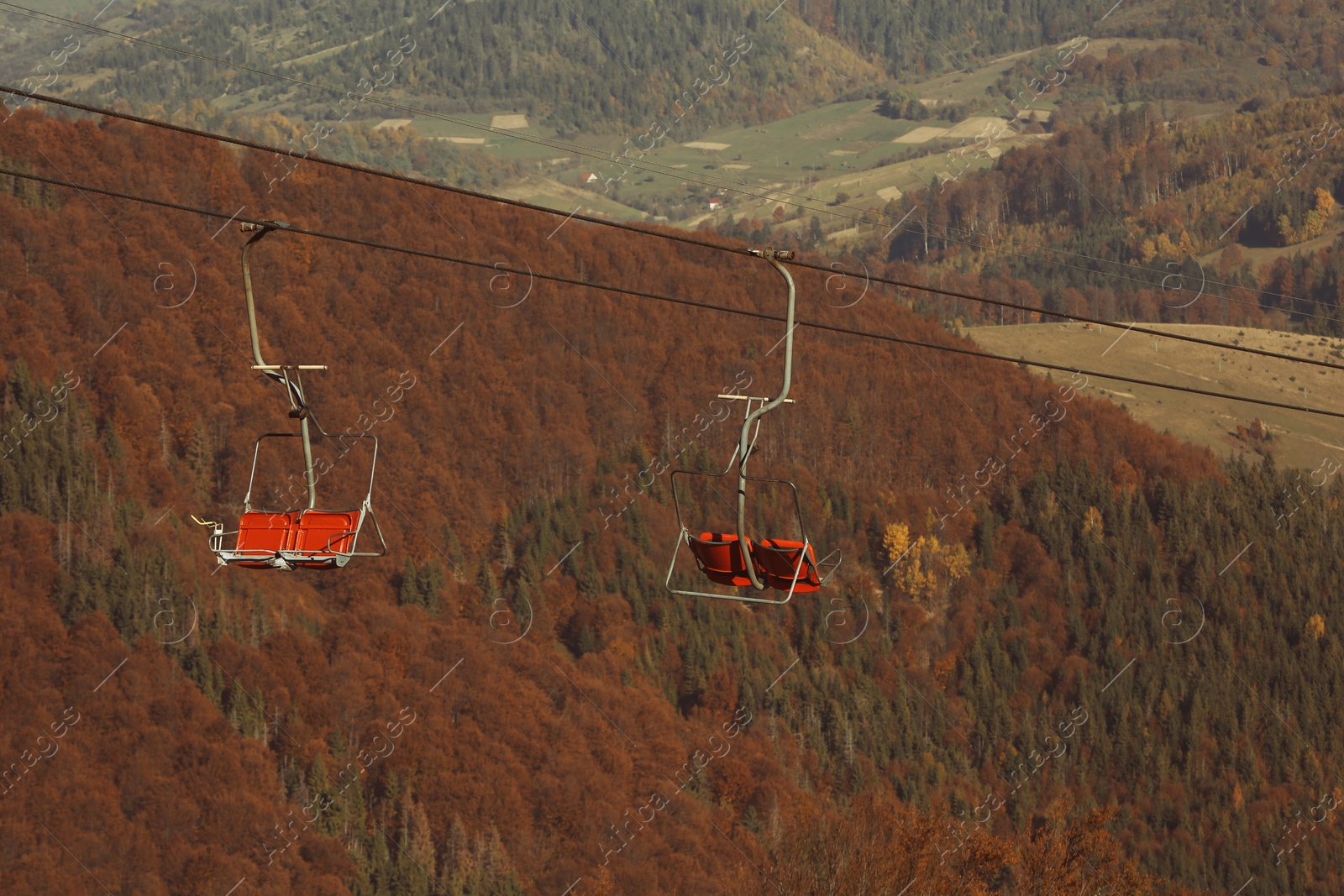 Photo of Chairlift with comfortable seats at mountain resort