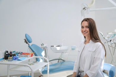 Portrait of professional dentist at workplace in clinic