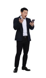 Photo of Shocked businessman in suit with smartphone on white background