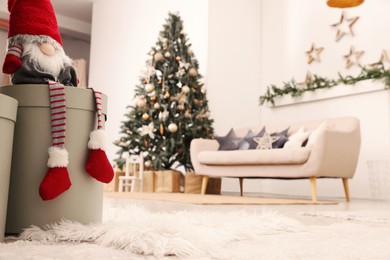 Photo of Living room interior with Christmas tree, focus on decorative dwarf. Space for text