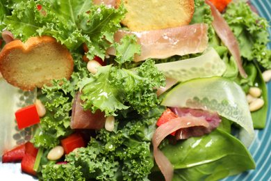 Photo of Plate with delicious salad with kale leaves, closeup