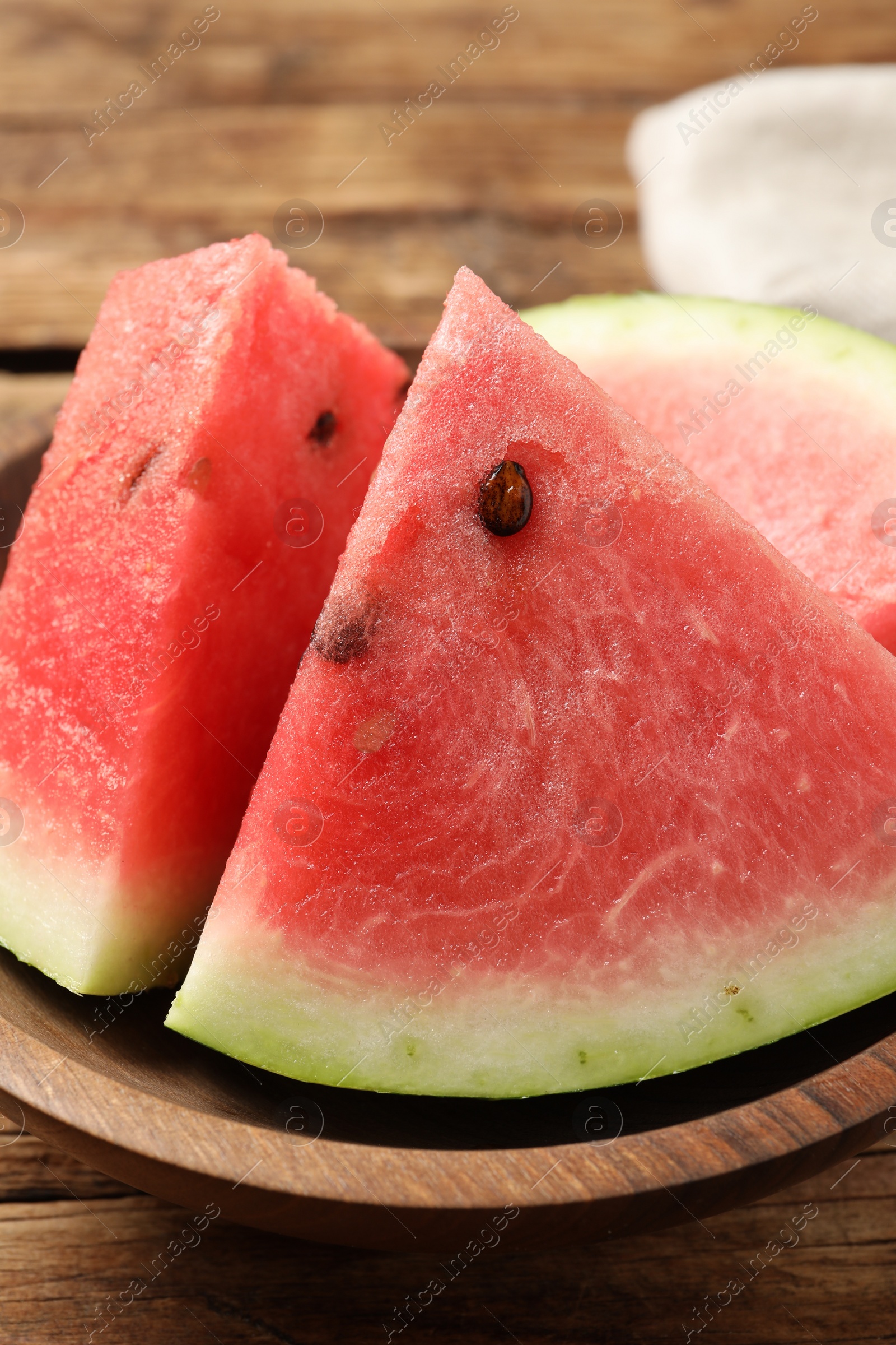 Photo of Delicious fresh watermelon slices on wooden table, closeup