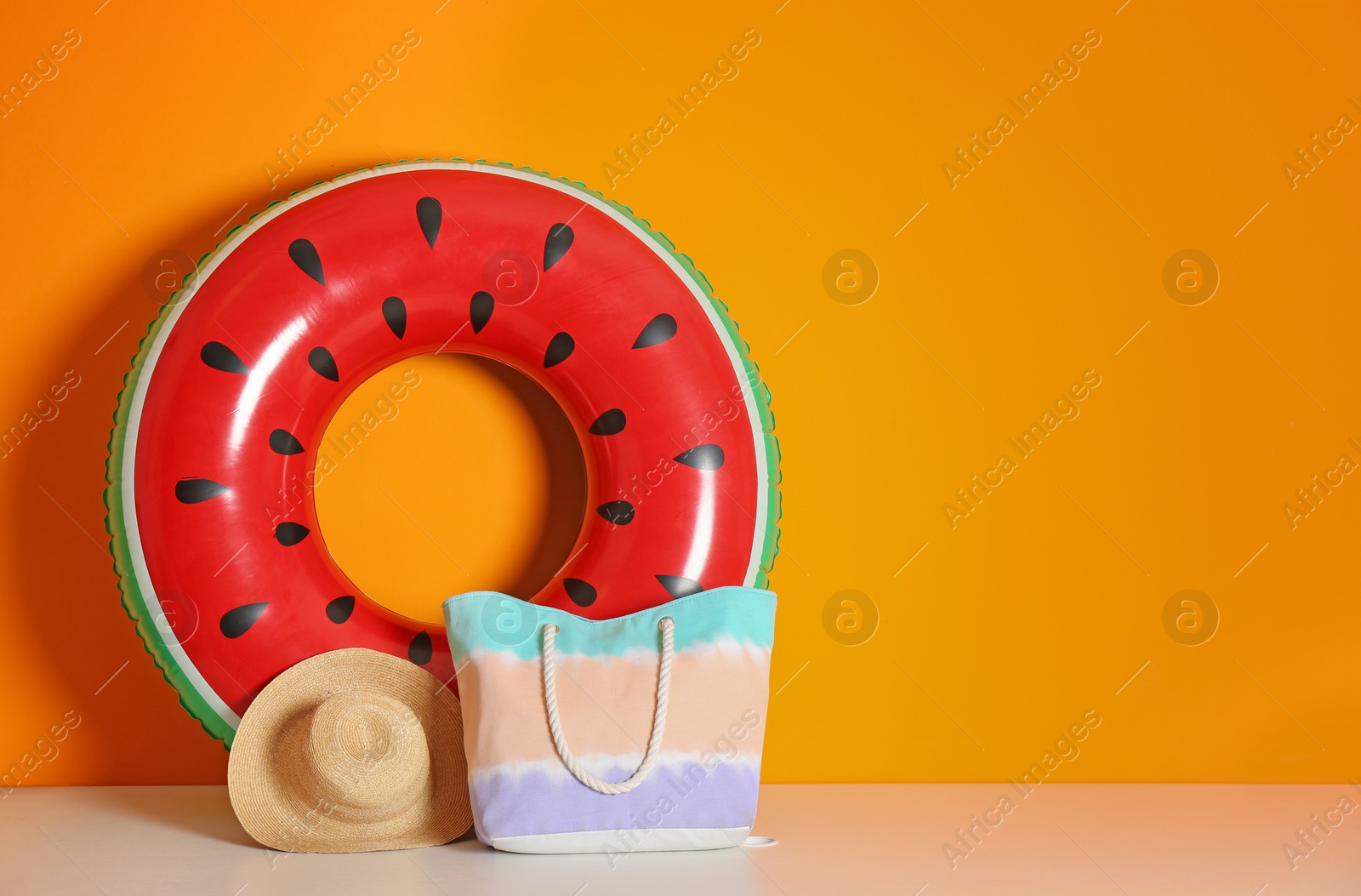 Photo of Beach objects near color wall with space for design. Summer vacation