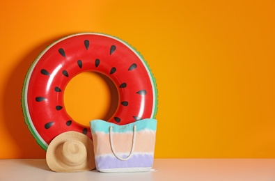 Beach objects near color wall with space for design. Summer vacation