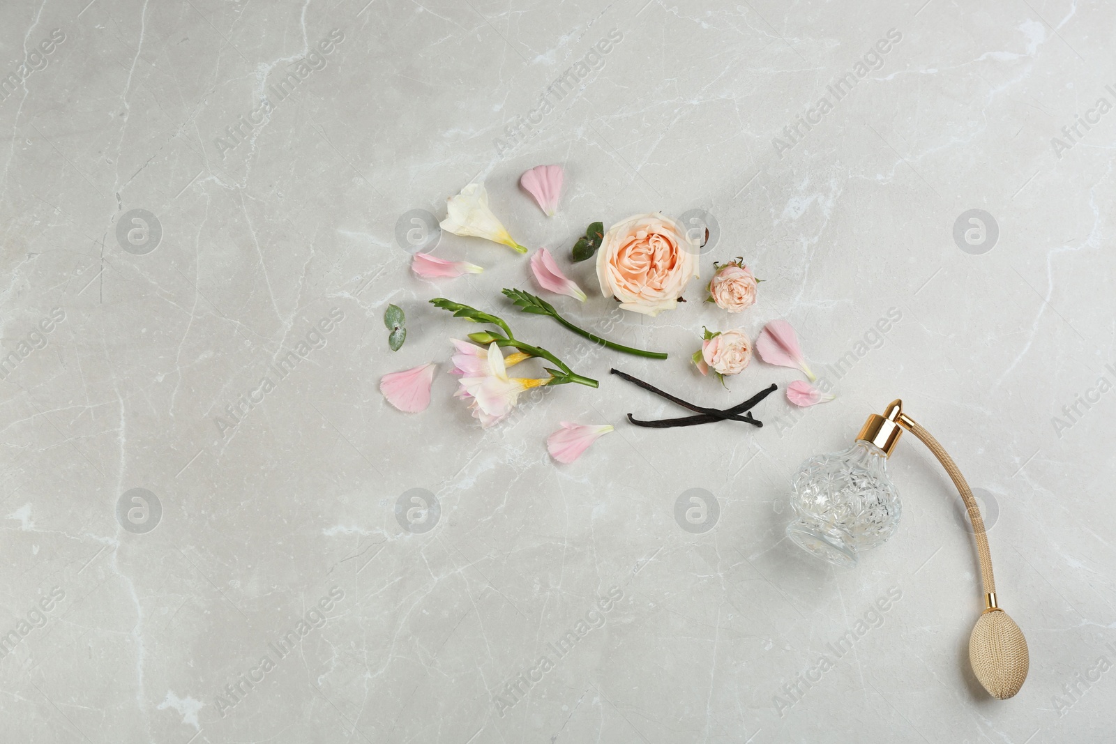 Photo of Flat lay composition with bottle of perfume on marble background