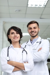 Portrait of doctors in coats at workplace