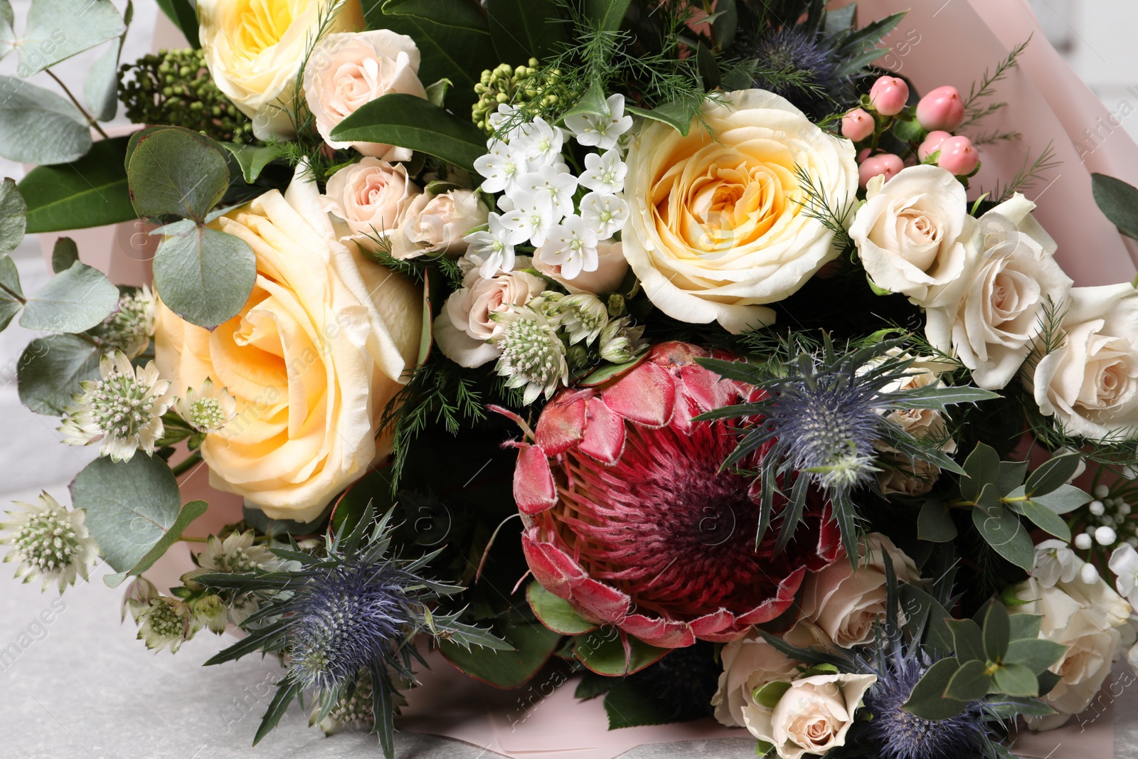 Photo of Beautiful bouquet with roses and leaves, closeup