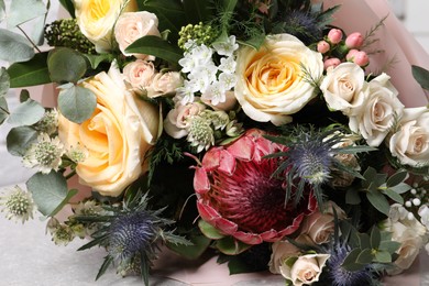 Photo of Beautiful bouquet with roses and leaves, closeup