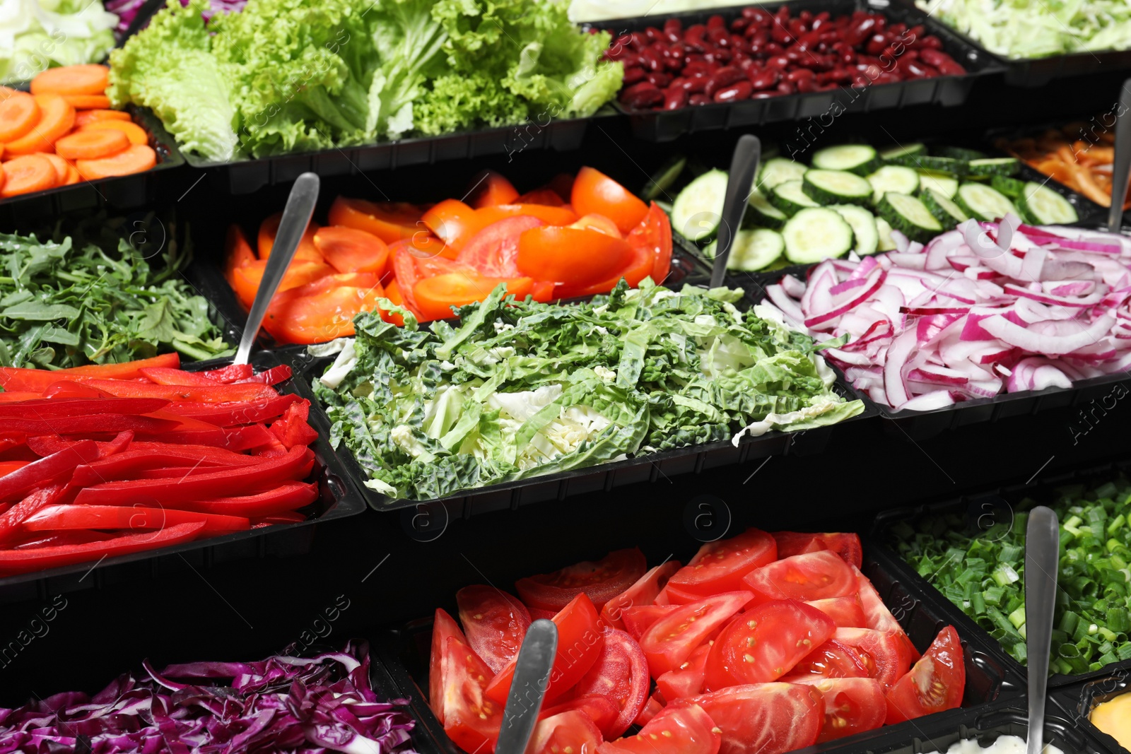 Photo of Salad bar with different fresh ingredients as background