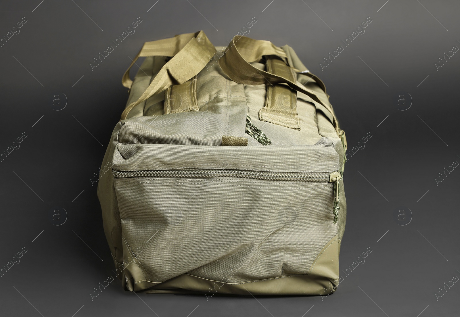 Photo of Army bag on dark grey background. Military equipment