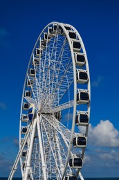 Photo of Beautiful large Ferris wheel against blue sky
