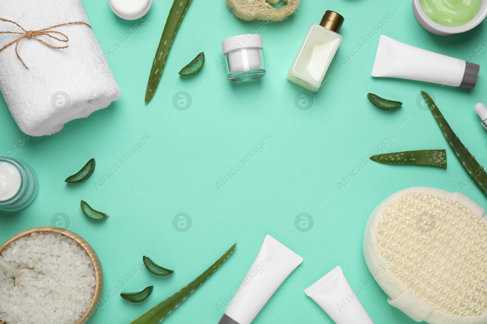 Photo of Flat lay composition with aloe vera and cosmetic products on turquoise background. Space for text