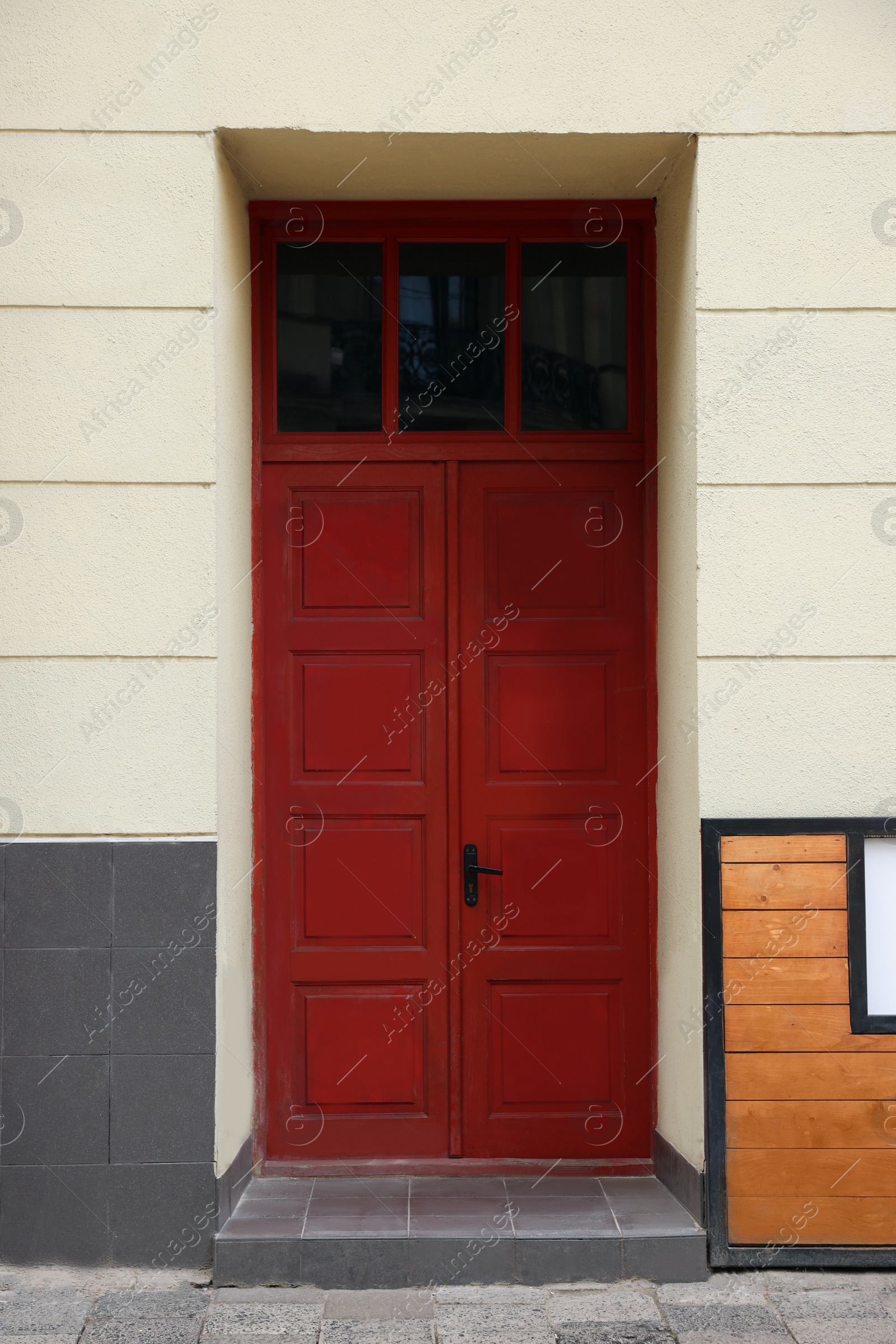 Photo of Entrance of house with beautiful red door and transom window