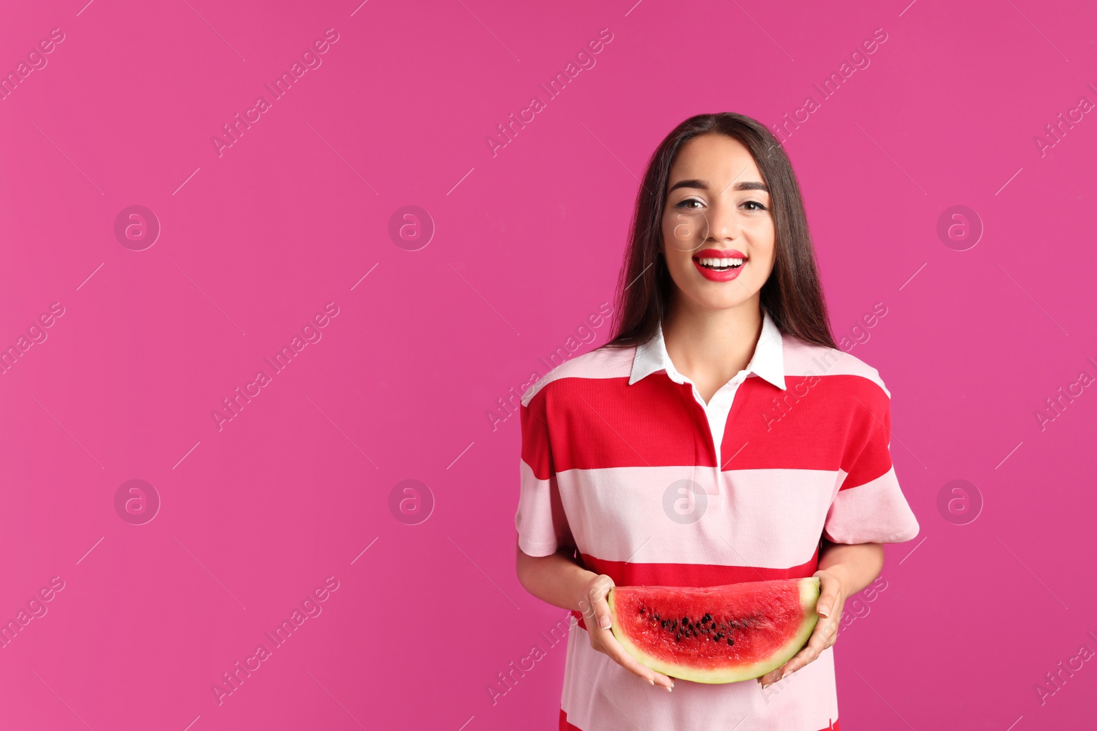 Photo of Beautiful young woman posing with watermelon on color background