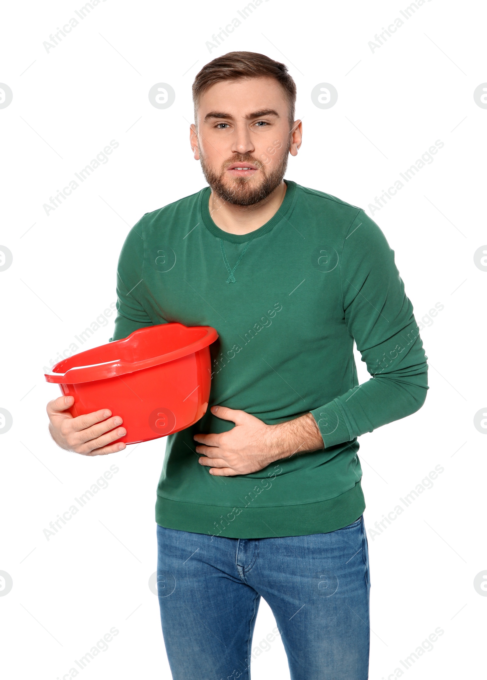 Photo of Young man with basin suffering from nausea isolated on white