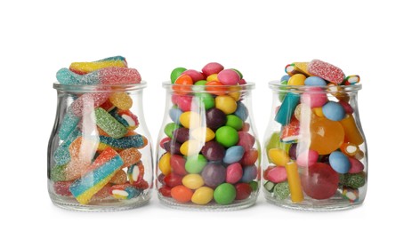 Photo of Glass jars with different candies on white background