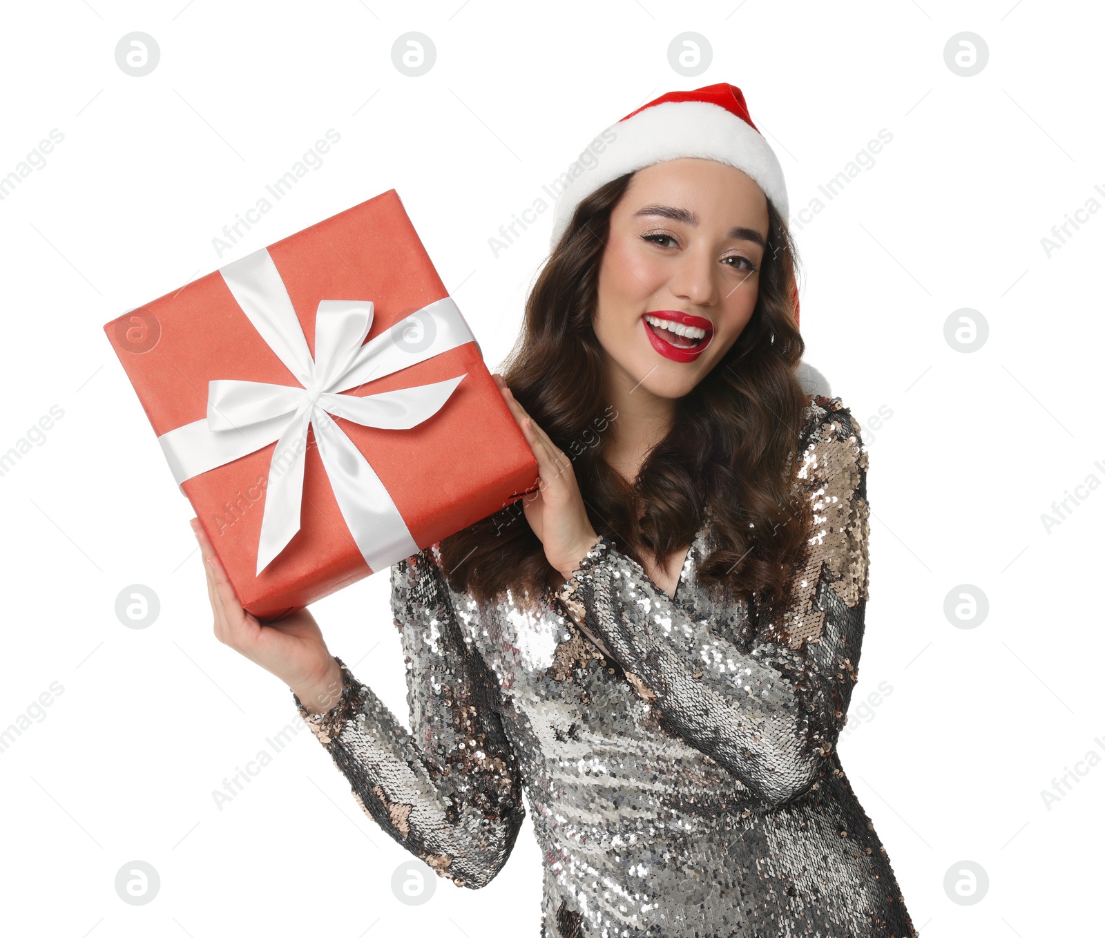 Photo of Beautiful young woman in stylish dress and Santa hat with Christmas celebration gift isolated on white