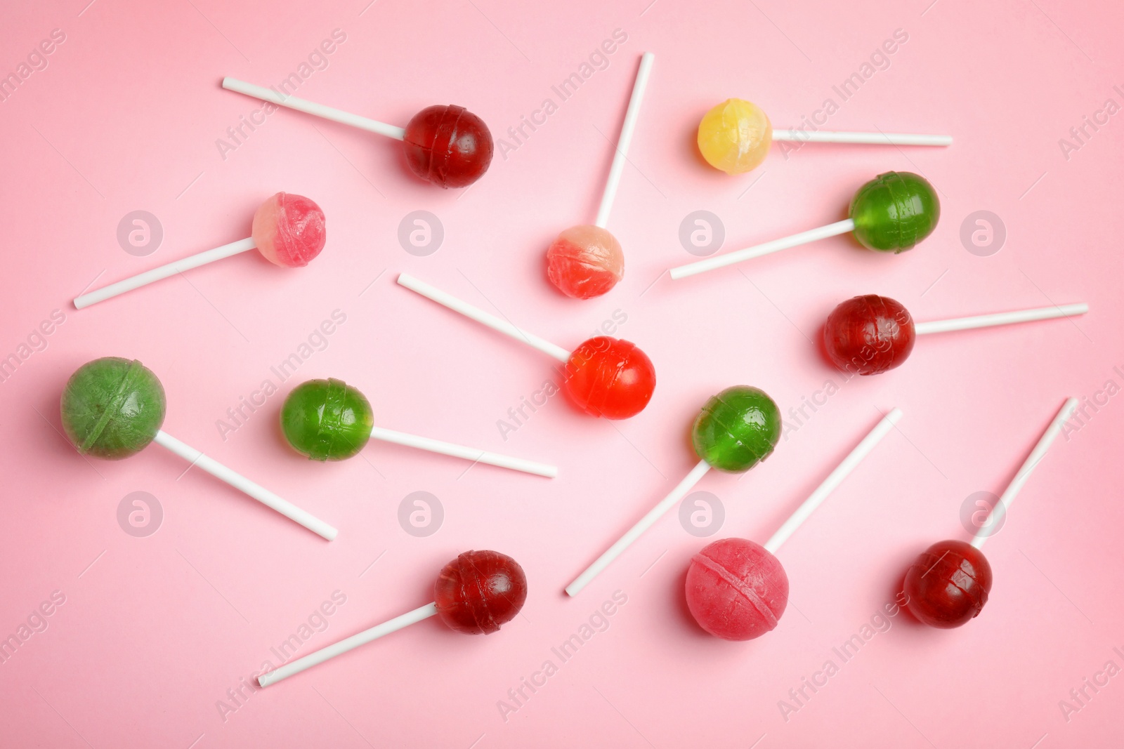 Photo of Flat lay composition with delicious colorful candies on color background