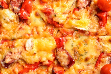 Photo of Delicious pizza with sausages and tomatoes, closeup