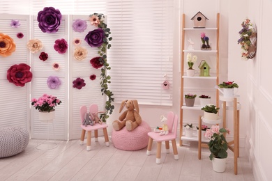 Easter photo zone with floral decor and chairs indoors
