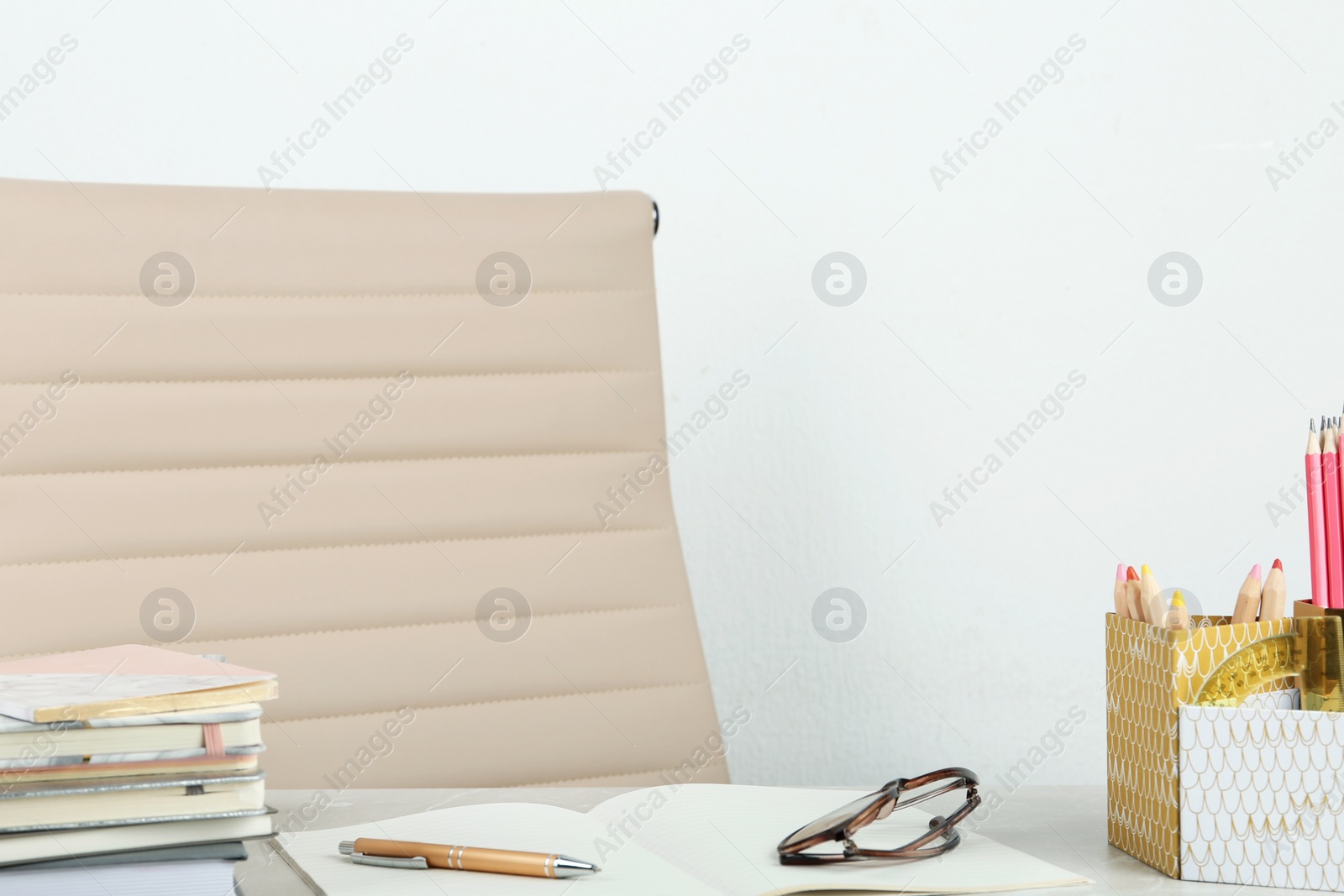 Photo of Stationery and notebooks on table against white wall, space for text. Happy teacher's day