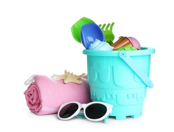 Photo of Set of plastic beach toys, sunglasses and blanket on white background