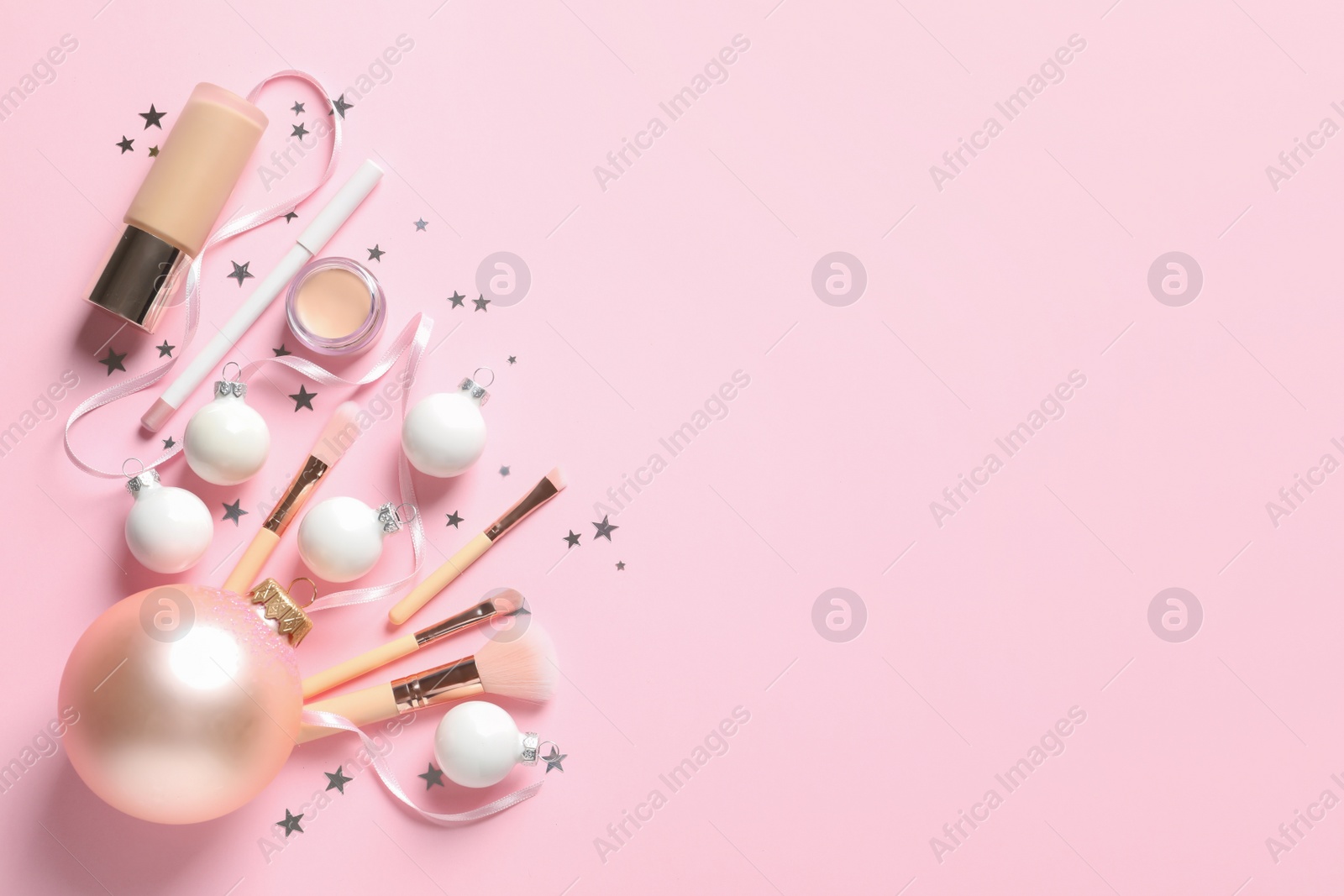 Photo of Flat lay composition with makeup products and Christmas decor on color background. Space for text