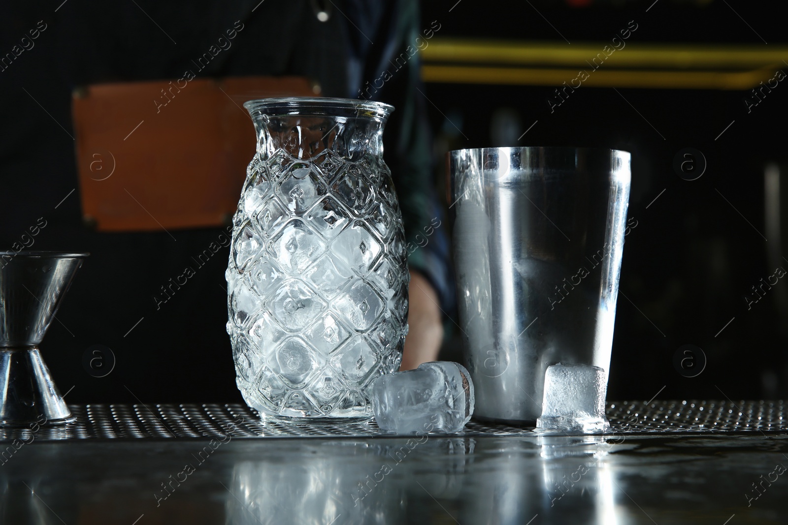 Photo of Professional barman equipment for making cocktails on counter in pub