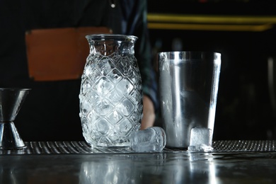 Photo of Professional barman equipment for making cocktails on counter in pub