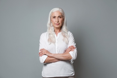 Photo of Portrait of beautiful mature woman on grey background