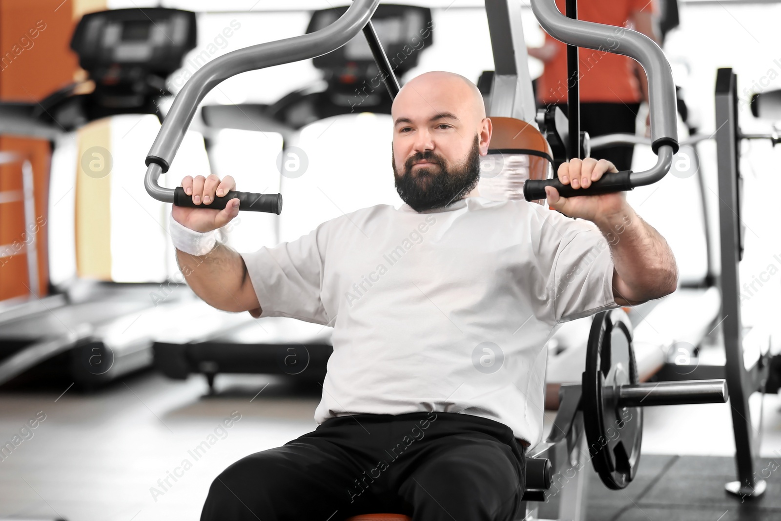 Photo of Overweight man training in gym