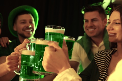Photo of People with beer celebrating St Patrick's day in pub