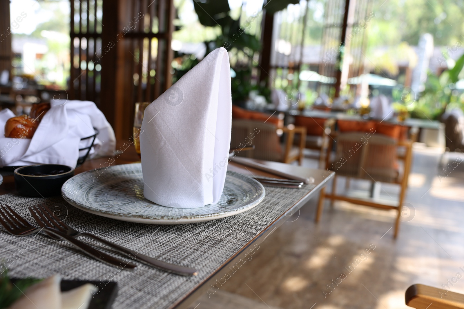 Photo of Dishware and cutlery on table in cafeteria, closeup. Breakfast, lunch or dinner time