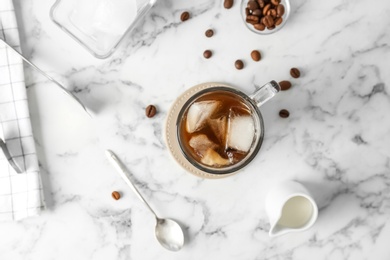 Photo of Glass cup with cold brew coffee on light background, top view