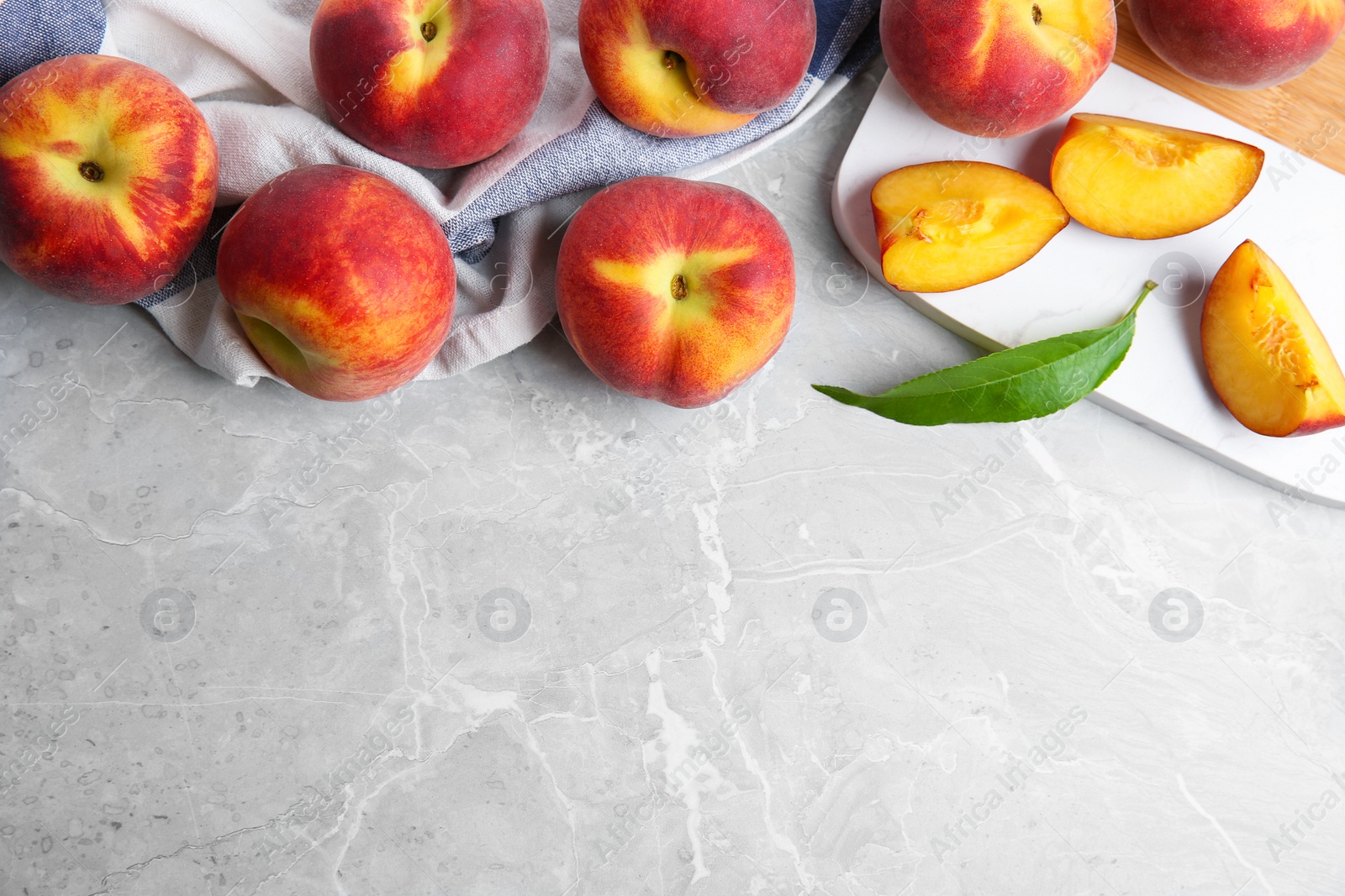 Photo of Flat lay composition with fresh peaches and space for text on marble background