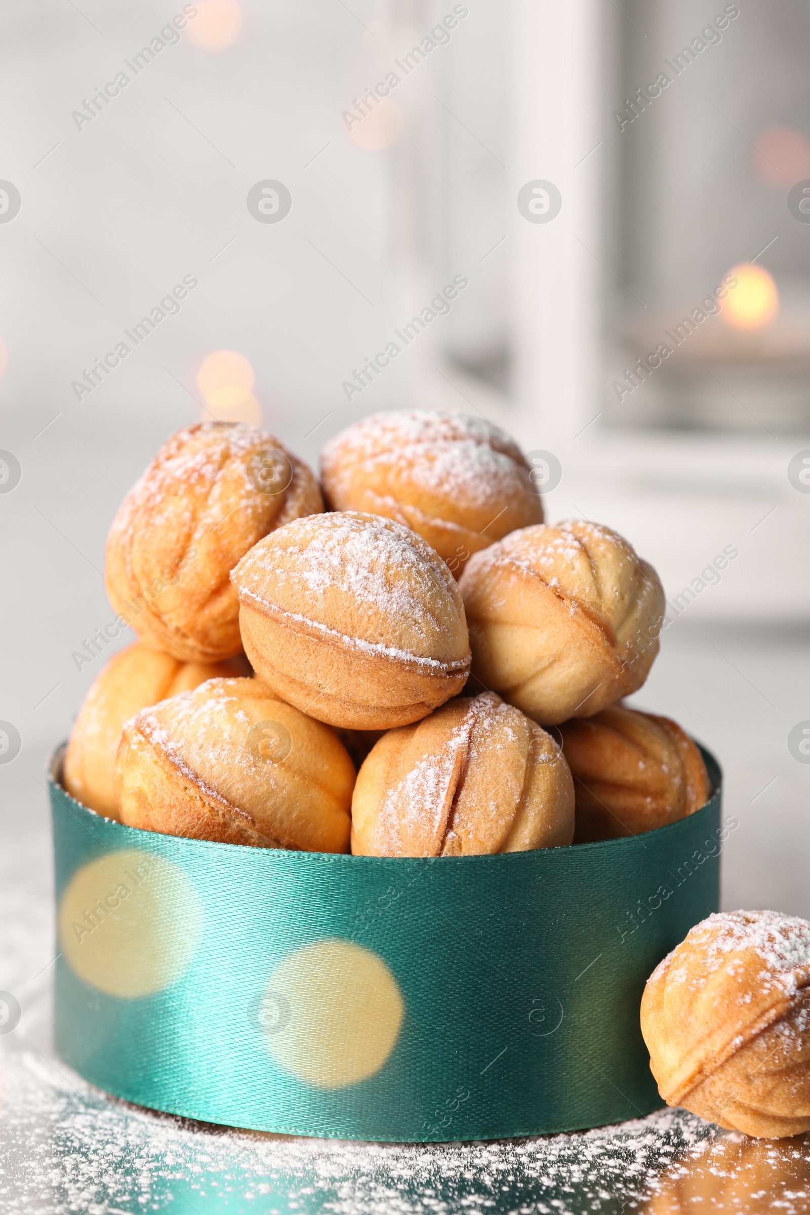 Photo of Box with delicious nut shaped cookies on white table, closeup