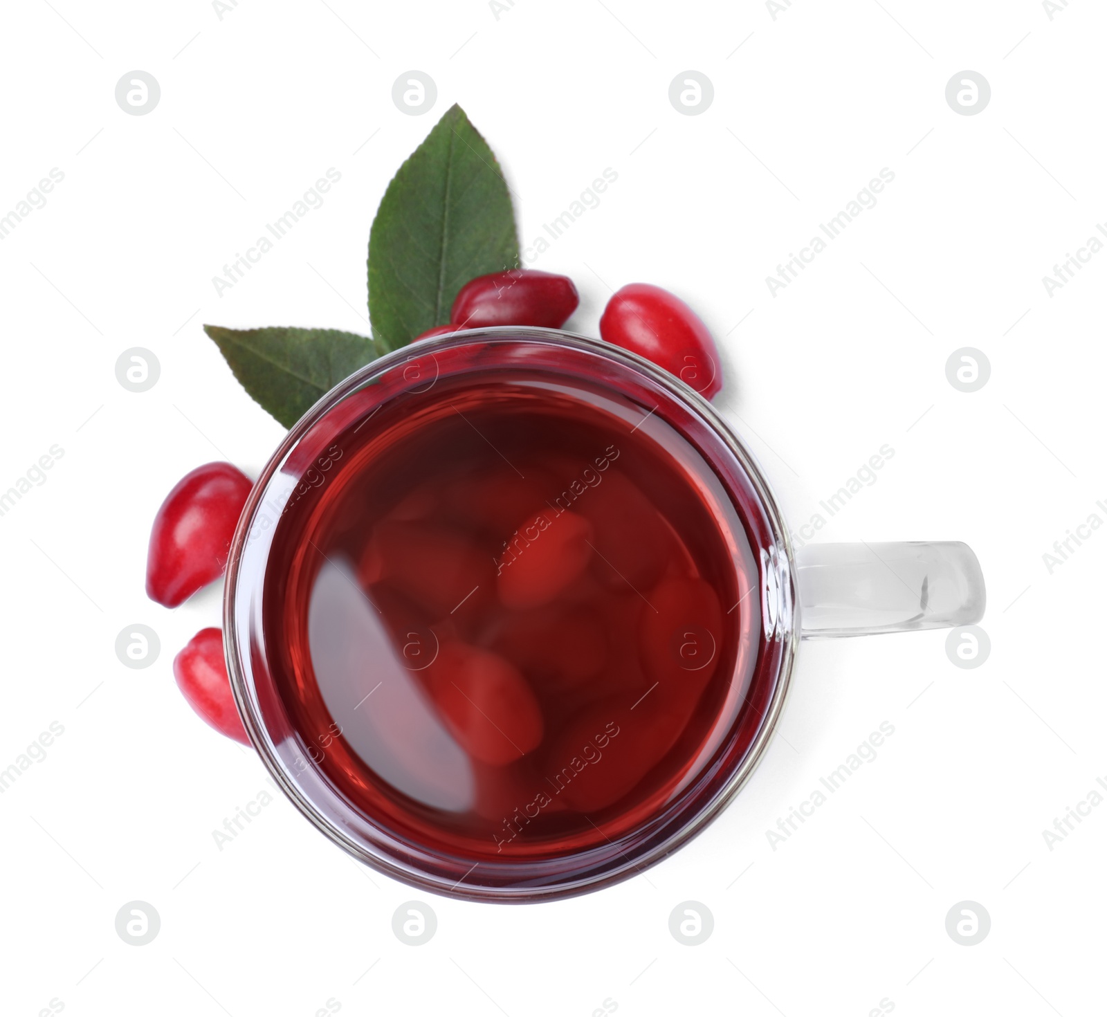 Photo of Glass cup of fresh dogwood tea, berries and leaves on white background, top view