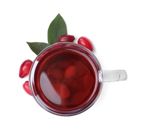 Glass cup of fresh dogwood tea, berries and leaves on white background, top view